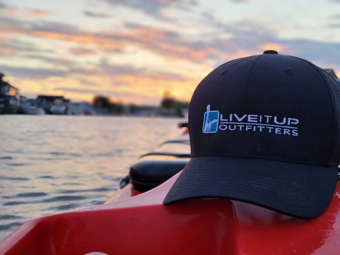 Live it Up Hat Apparel on Kayak in New Jersey Barnegat Bay while Exploring and Finding New Things to Do Outdoors and in Nature Black Baseball Cap Vented High Performance Activewear with Sunset