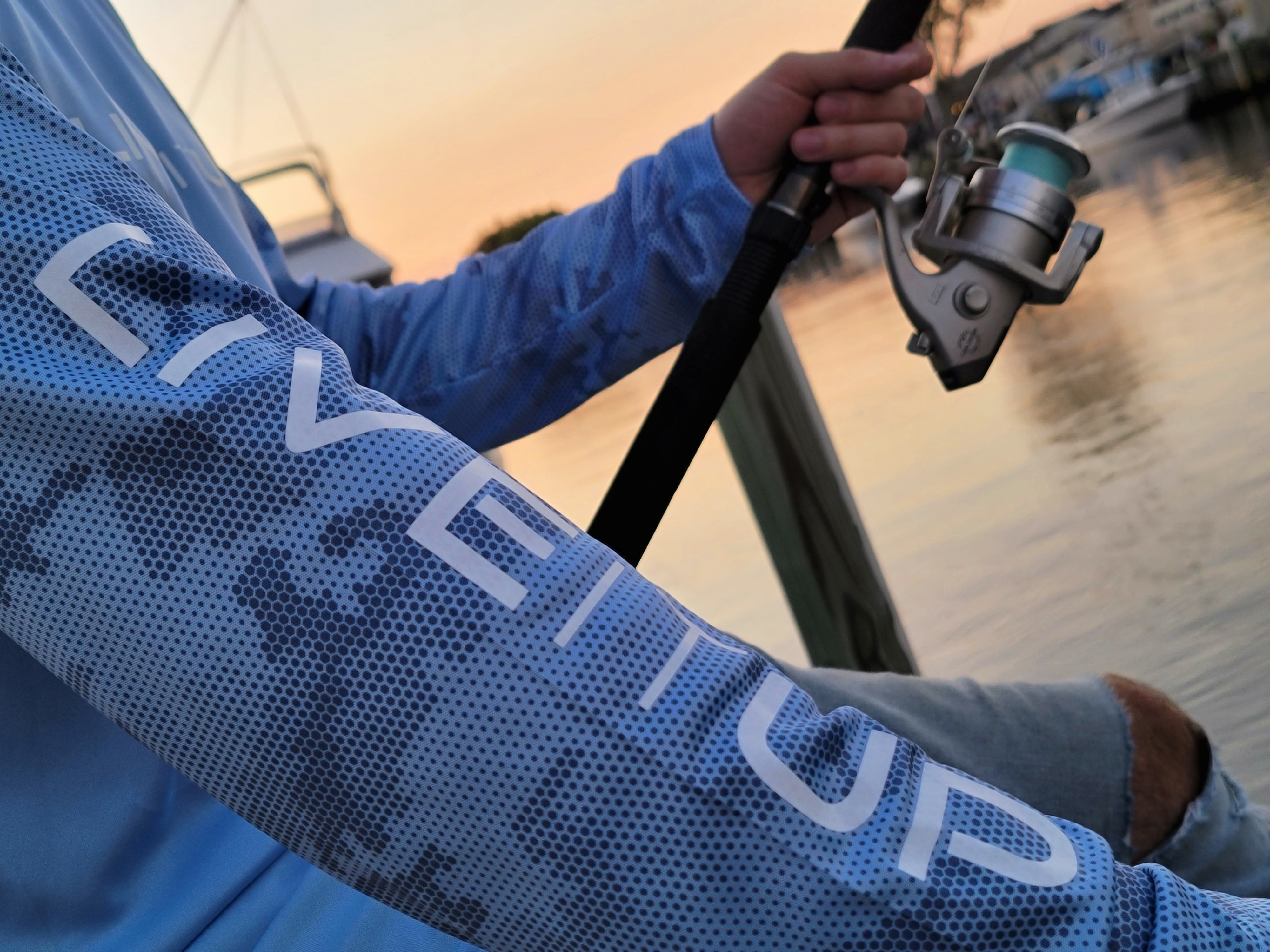 Live it Up Perfomance Fishing Shirt UV Protection Apparel with Fishing Pole near Barnegat Bay in New Jersey while Exploring and Finding New Things to Do Outdoors and in Nature High Performance Activewear for Fishing